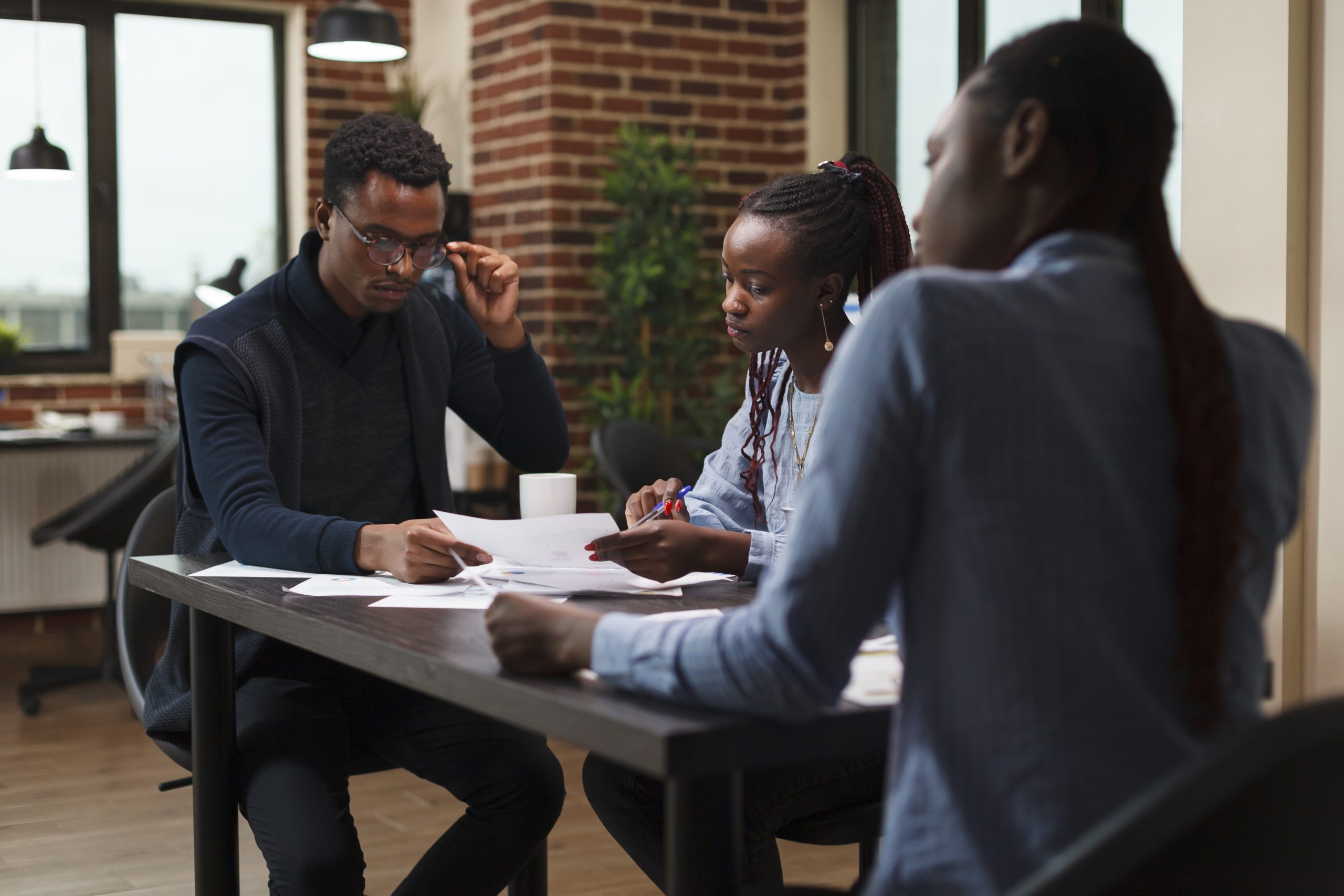 African american research agency coworkers in meeting about startup project financial status.